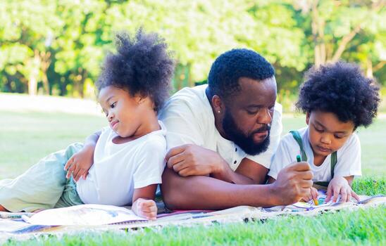Family happy to lie down on the lawn in the park on vacation. Concept of love and family ties photo