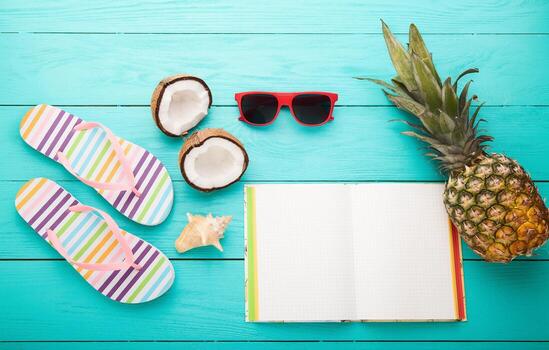 Flip flops, sunglasses and sea shell on blue wooden background. Copy space and fashion summer accessories. photo