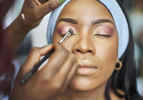 Visagiste applying makeup photo