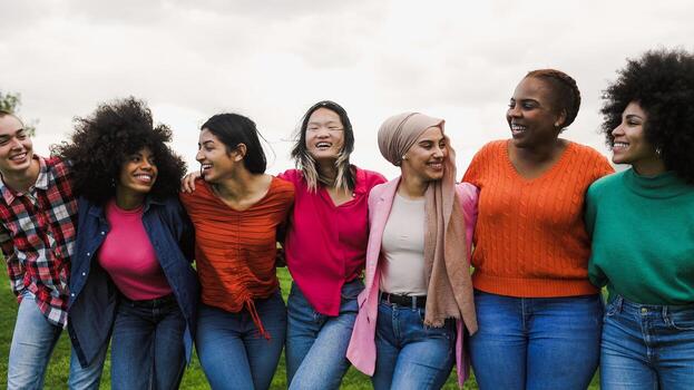 Happy young multi ethnic women having fun in a park - Diversity and friendship concept photo